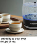 Fast 1.8L Electric Kettle 1500W For Quick Boil Tea Coffee With clear glass, boiling water, next to cups of tea on a tray.