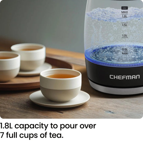 Fast 1.8L Electric Kettle 1500W For Quick Boil Tea Coffee With clear glass, boiling water, next to cups of tea on a tray.