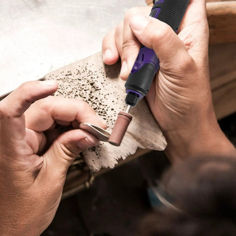 Hands using Tough As Nails Multi Speed Mini Electric Angle Grinder with sanding bit on wood for detailing crafts.