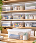Clear Plastic Storage Bins With Tight Snap On Lids 6 Quart Stackable Boxes organized on shelves storing towels, toys, and office supplies.