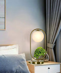 Gold Brass Finish Oval Bedside Table Lamp With Milky White Shade For Living Room And Bedroom Cozy Glow Soft Reading Light placed on a nightstand