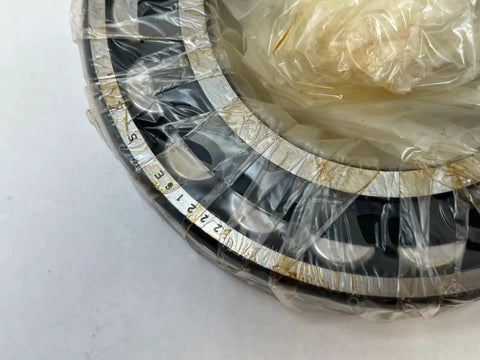 22216 Spherical Roller Bearing With 80mm Inner Diameter and 140mm Outer Diameter Measuring 33mm Wide, wrapped in plastic.