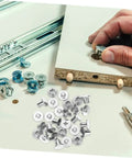 Built Tough Chicago Style Binding Screws For Books And Scrapbooks And Paper Crafts Using 75 Piece Silver Carbon Steel Fasteners on craft table.