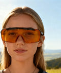 Badass Heavy Duty UV Safety Glasses Engineered To Block Harmful 254Nm UV Rays For Tlc Lab Tasks Ansi Z 871 Certified Industrial Grade Wraparound Goggles worn by a woman outdoors.