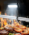 Rechargeable Grill Light For Outdoor Grills 400LM LED with Auto On Off Sensor illuminating food on grill.