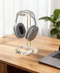 Crystal Clear Acrylic Headphone Stand With Gold Hardware Dope Look Ultra Sturdy Desk Earphone Holder For Gaming Room And Office Sleek Modern Display Keeps Your Headset Upright Neatly Organized And Always Within Reach on a desk with headphones.
