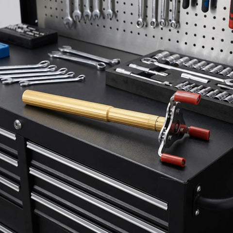 Ladder Free Smoke Sensor Assembly Removal Tool With A Rock Solid Aluminum Jaw And Extended Reach For High Ceiling Fire Alarm Extraction Drop Your Ladder Today on a workbench.