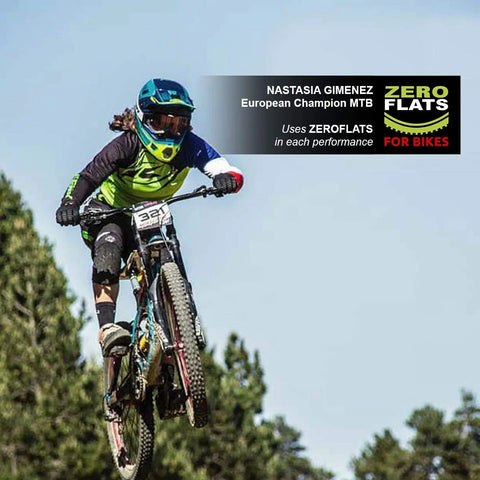 Mountain biker performing jump using Anti-Puncture Bike Tire Sealant, 8.45oz, Ultra-Fast Liquid For Standard, Tubeless, and Tubular Tires