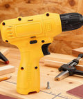 Heavy Duty Cordless Electric Drill Kit With Ergonomic Soft Touch Grip And Rapid Bit Exchange, yellow drill on wooden workbench.
