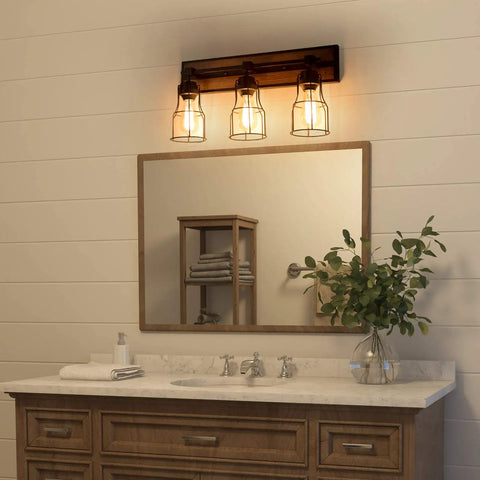 Bathroom setting with two light farmhouse vanity light with vintage black metal cage and rustic wood finish above mirror