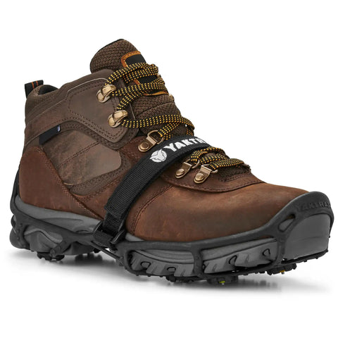 Heavy Duty Tungsten Carbide Spikes For Ice Walkers Large X Large Black Traction Cleats on brown footwear for icy surfaces.