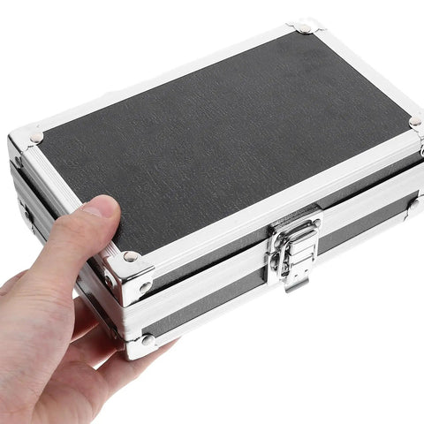Rugged As Nails Portable Aluminum Tool Box With Secure Locking Lid And Impact Resistant Carry Case featuring a hand holding the black aluminum case.