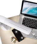 Purify LED Desk Lamp With Wireless Charging, Touch Activated, Flexible Gooseneck on a desk with laptop and phone