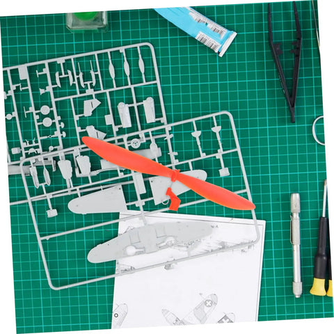 Plastic Model Airplane Propellers Replacement Parts Set For DIY Aircraft And RC Helicopters on green cutting mat