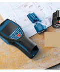Pro Level Stud Finder and Wall Scanner boasting dead-on metal scanning on a workbench with accessories and plans.