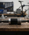 Solid Alloy Bike Bottom Bracket 73x124mm For E-Bikes With Iso Square Taper Fits Your Ride And Handles Harsh Snow Or Beach Sand Like A Boss Without Any Wobbly Issues on workbench