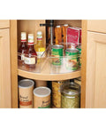 Smooth Spinning Lazy Susan Cabinet Organizer Bins For Kitchen 8 Pack arranged with bottles and cans in a corner cabinet.