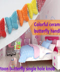 Top Shelf Red Butterfly Cabinet Knobs And Vintage Drawer Pulls Set Of Six With Glossy Ceramic Finish And Zinc Alloy Base That Looks Dang Sharp On Any Kitchen Dresser Or Cupboard - Colorful ceramic butterfly knobs displayed.