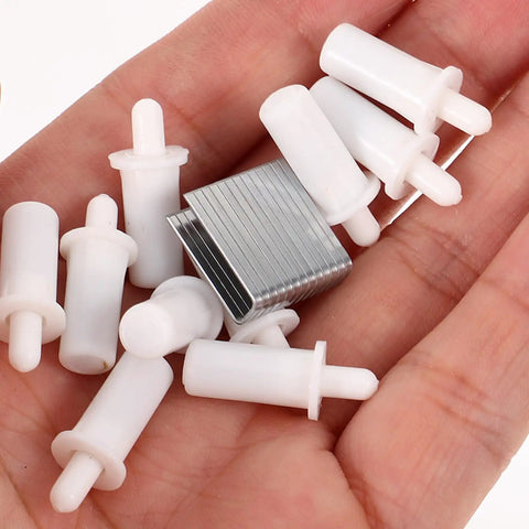 Kick Your Broken Shutters To The Curb With These Top Shelf Repair Pins And Zero Point Six Inch Metal Blind Louver Fixing Kit - white plastic and steel pins in hand.