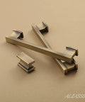 Brushed Antique Brass Cabinet Pulls 5 Inch Drawer Handles 10 Pack Solid Hardware Kitchen Cupboard Knobs on beige surface.