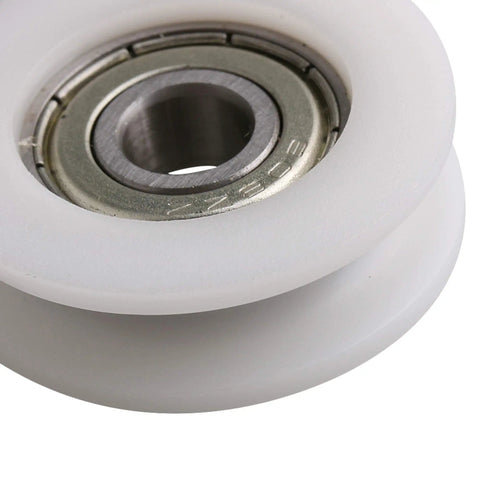 Four Pc U Groove Pom Pulleys With Eight mm Bore And 34 mm Outer Diameter close-up view of white POM pulley and inner bearing.