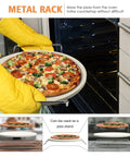 5 Piece Round Pizza Stone Set With 13 Inch Stone, Serving Rack in use with pizza being placed into the oven.