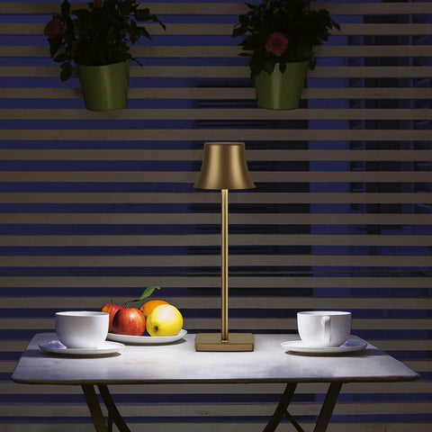Cordless Table Lamp 2 Pack With 5000mAh Rechargeable Battery Metal USB LED Desk Light on a table with cups and fruit, antiqued gold finish