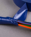 Close-up of Contractor Favorite Pro Grade Multicolor Electrical Tape applied on wires, showing blue vinyl tape in use.