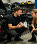 Ditch The Gunk And Keep Your Engine Sleek With This Rock Solid 300Ml Oil Catch Can Kit shown with two people discussing its features.