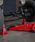 Heavy Duty Hydraulic Low Profile Floor Jack With Dual Piston Quick Lift Pump And 3.5 Ton 7000 Lb Capacity under a vehicle wheel.