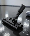 Floor Coating Roller Clamp Accessory With Metal Handle And Hinge Joint Rectangular Base Clamp Tool For Flooring Projects Workshop Tasks Contractor Jobs Home Renovation And DIY Setup black metal clamp on glossy floor