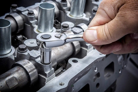 Using 43 Piece 1/4 Inch Drive SAE and Metric Socket Set with Ratchet Quick Release 72-Tooth on engine component