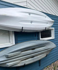 Top Shelf Badass Kayak Wall Mount Rack For Garage Storage with three kayaks securely hung on a blue wall.