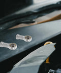 Rock Solid Four Pack M10x1.25 Internal Thread Fish Eye Radial Bearing Kit on a tool surface, showing two steel rod end bearings.