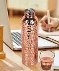 Copper Water Bottle With Easy Temperature Control And Built Tough Leakproof Insulated Design on office desk
