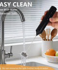 Rechargeable Handheld Milk Frother With Stand 3 Speeds And 3 Detachable Stainless Steel Whisks Electric Drink Mixer being rinsed under a faucet