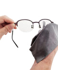 Xthel microfiber glasses cleaning cloth, gray, close-up view with eyeglasses