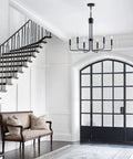 Matte Black Farmhouse Chandelier With Six Lights Modern Industrial Candle Pendant in elegant foyer.