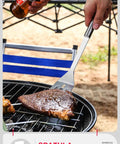 Person using stainless steel spatula to flip steak on grill, part of Stainless Steel Grill Tool Set With Chef Spatula Tongs And Fork Outdoor Barbecue Utensils Kit Built To Last Travel Ready Grilling Accessories For Home Or On The Go A Smart Gift For Grill Masters.