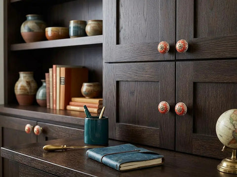 Sick Red Ceramic Cabinet Knobs Set for Fresh Kitchen and Dresser Upgrade on dark wood cabinet with decor.