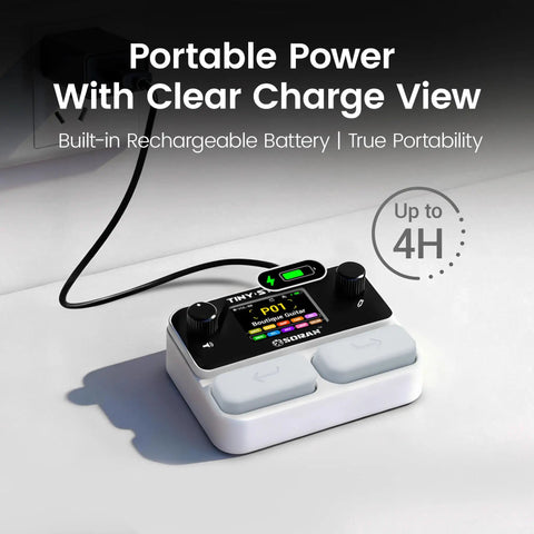 Tiny Stomp Multi Effects Guitar Pedal With 125 Effects 99 Presets 10 Modules, charging on a desk, display showing status