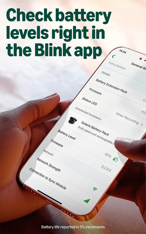 Person holding phone showing Blink app with Solar Panel Security Accessory For Outdoor 4 And Outdoor 2K Plus Battery Cameras.