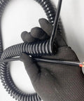 Premium Two Core One Point Five Millimeter Coiled Spring Cable With Bare Copper Conductors held in hand showing coiling and exposed ends.