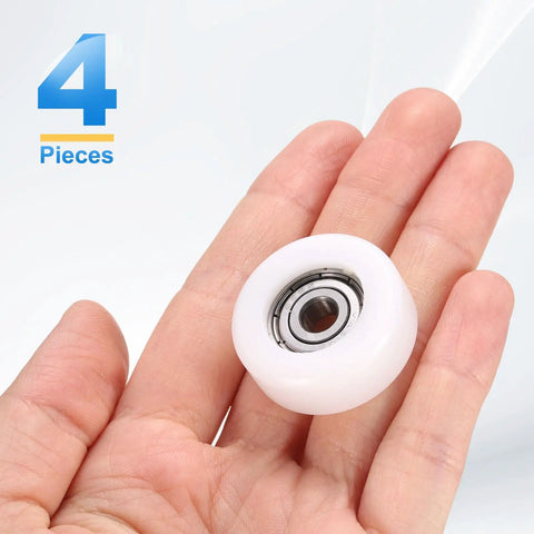 4 Pack White Roller Idler Bearing Pulleys With 626ZZ Bearings Butter Smooth Gliding Conveyor Track Wheels held in hand.