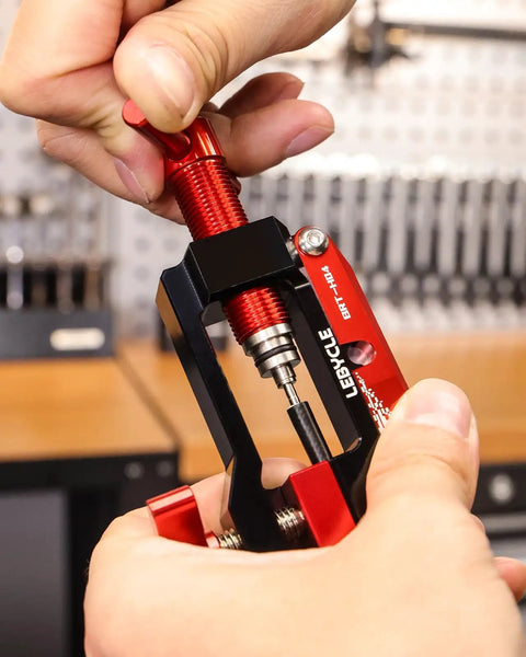 Close-up of hands using 3 In 1 Hydraulic Brake Tool For Bikes Hose Cutter Needle Driver And 7 8mm Brake Line Wrench in workshop