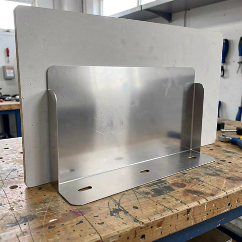 Stainless Steel EV Charger Weatherproof Cover All Season Heavy Duty Rainproof Housing For Outdoor Charging Posts on wooden workbench.