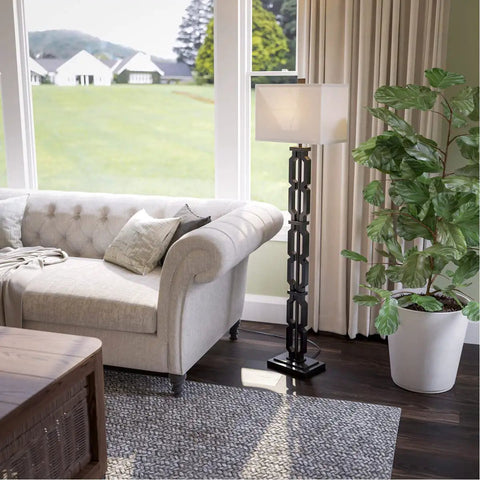 Tall Black Floor Lamp With White Rectangular Shade, 59.5 Inch Height, 16 Inch Width, 9 Inch Extension, 3 Way Socket Switch, Plastic Construction, Uses One 150 Watt Bulb, Easy Assembly With Mounting Instructions by a sofa in a living room.