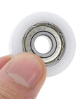 Four Pack Nylon Pulley Wheels Featuring 30mm Sealed Bearing Rollers For Silky Smooth Track Door And Cabinet Slide, finger holding wheel.