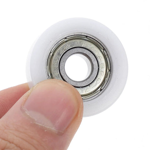 Four Pack Nylon Pulley Wheels Featuring 30mm Sealed Bearing Rollers For Silky Smooth Track Door And Cabinet Slide, finger holding wheel.
