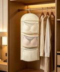 Game Changer Closet Suspending Organizer With Sturdy Metal Hanger And Three Tier Mesh Pockets For Dorm Rooms And Small Spaces hanging in a closet with bras.
